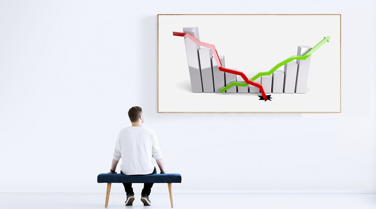 Imagem mostra investidor analisando gráficos para fazer long & short