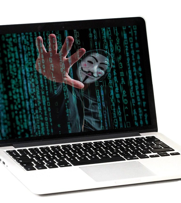 Imagem mostra hacker invadindo computador representando golpes financeiros